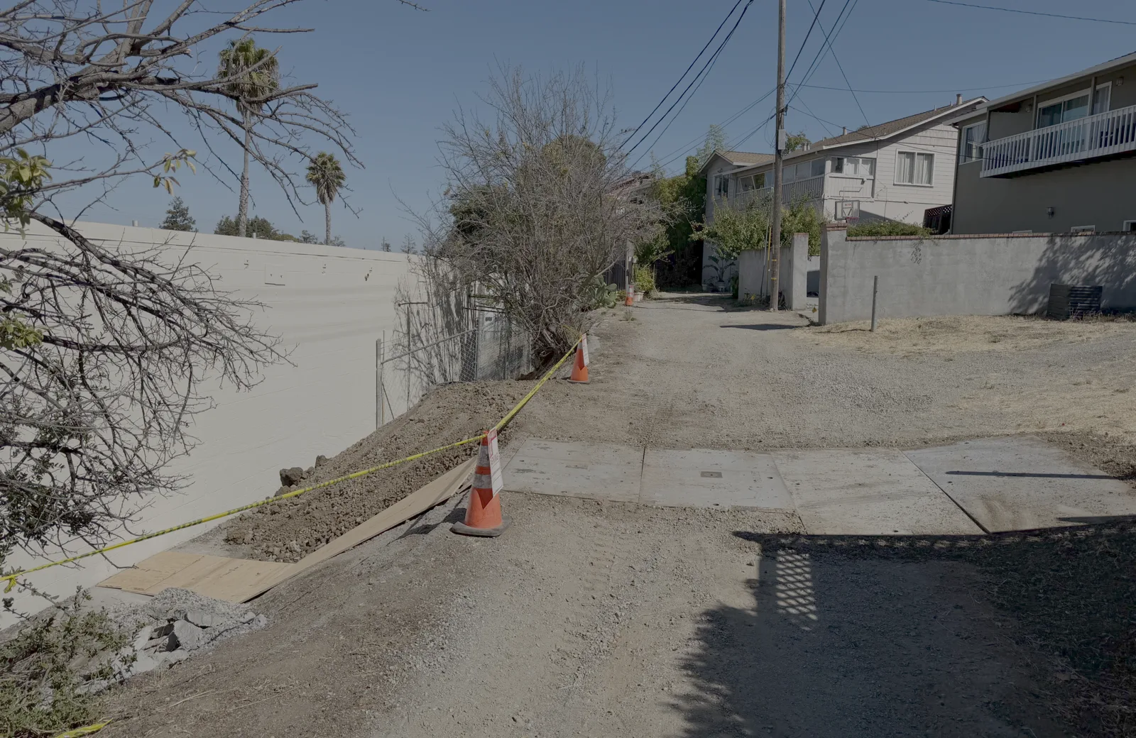Plated gas trench crossing an alleyway easement in Belmont, restored to the mainline